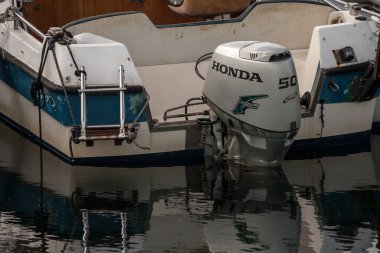 KOPER, SLOVENIA - SEPTEMBER 17, 2021: Honda logo on a boat engine,motorboat, in the port of Koper. Honda is a Japanese car and automotive manufacturer, spread worldwide