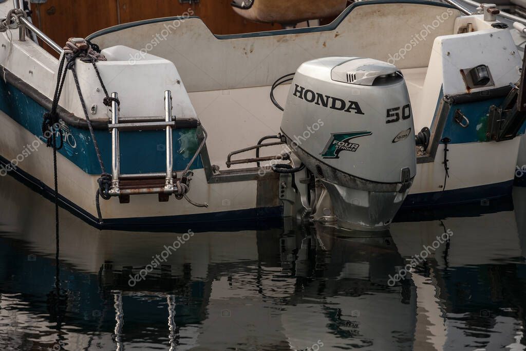 KOPER, SLOVENIA - SEPTEMBER 17, 2021: Honda logo on a boat engine,motorboat, in the port of Koper. Honda is a Japanese car and automotive manufacturer, spread worldwide