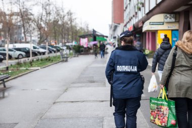 NOVI SAD, SERBIA - 3 Nisan 2022: Ülkenin sivil polis teşkilatına bağlı Novi Sad sokaklarında yürüyen kadın ve kadın Sırp polis memuru 