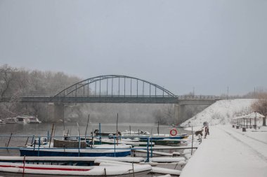 PANCEVO, SERBIA - 12 Aralık 2021: Tamiski nehri üzerindeki en seçici bulanıklık Tamis nehri üzerinde, Pancevo Rıhtımı 'nda, soğuk bir kar fırtınası sırasında. Pancevo banatın en büyük şehirlerinden biridir.
