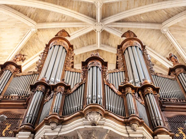 Pipe organ, also called grandes orgues, designed in France in the 18Th century, inside a catholic cathedral. Pipe organs are a majestic music instrument.