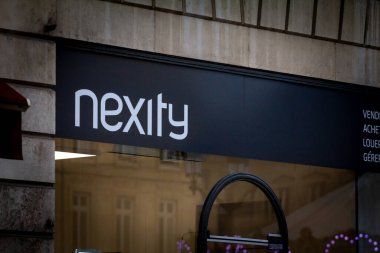 BORDEAUX, FRANCE - FEBRUARY 24, 2022: Nexity logo on their office for Bordeaux. Nexity is a french real estate development, promotion and construction company clipart
