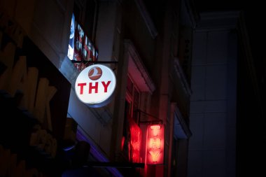 ISTANBUL, TURKEY - MAY 20, 2022: Selective blur on a THY sign at night, meaning Turk Hava Yollari, the turkish logo of Turkish airlines, It is the main airline and the flag carrier of Turkey, a major European company