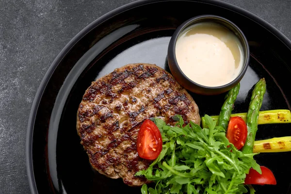 stock image Pork steak with sauce, herbs and tomatoes