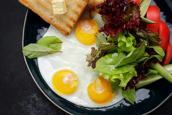 Завтрак Жареные Яйца Тостами Маслом Овощами Огурцами Помидорами Темном Фоне — стоковое фото