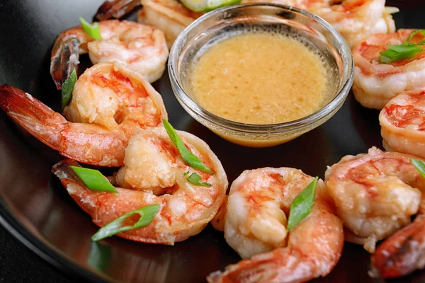 Fried crispy shrimp appetizer, selective focus. On a black background
