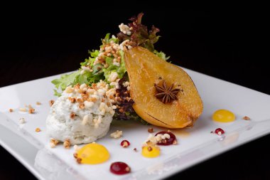 Dessert caramelized pear with blue cheese foam on a plate. selective focus