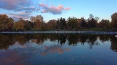 Autumn city park with a lake in the evening. Panorama