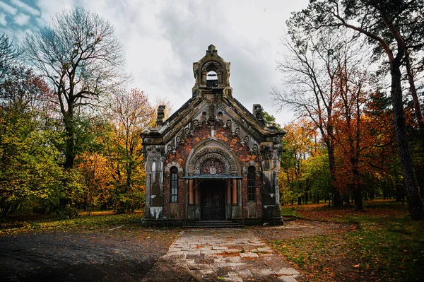 Ancient church in the middle of the autumn forest, clouds, artistic processing