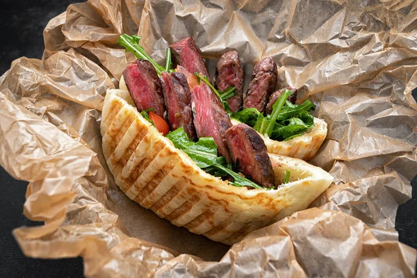 Gyros, shawarma with meat and herbs, on craft paper