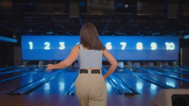 İspanyol bir kadın, kameraya sevinçle bakar ve zaferi ağır çekimde kutlar. Bowling salonuna atış yapmak için at. Zafer dansı ve mutlulukla zıpla.