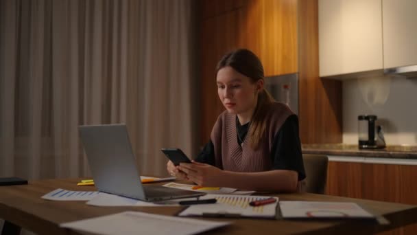 Woman working frome home, business female working on laptop and using mobile phone drinking coffee sitting on table in the garden in morning. Lifestyle women working at home concept. — Stock videók