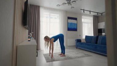 woman in sportswear doing workout burning fat calories training strength practicing effort domestic fitness females aerobics sport fit at home