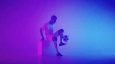 Siyah Afrikalı Freestyle ya da futbol topuyla bacak hokkabazlığı yapan profesyonel futbolcu, yavaş çekim. Profesyonel bir futbolcunun atölye çekimi.