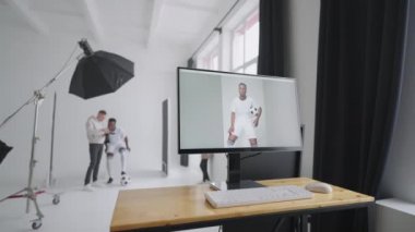Sportif siyah bir erkek model reklam posterleri için poz veriyor. Top 'la muhteşem atışlar için oynuyor. Şık Moda Spor Dergisi 'nden. Stüdyoda profesyonel ekipmanlarla yapılan bir fotoğraf çekimi.