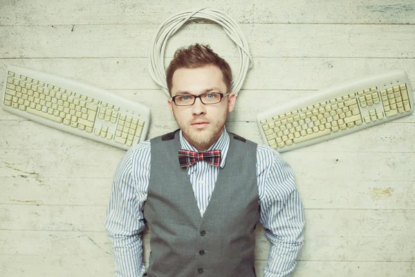 Young man like an angel with keyboards — Stock Photo, Image