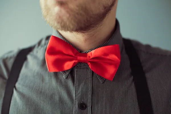 Bearded face and a red bowtie on the shirt — Stock Photo, Image