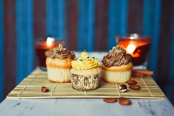 Cupcakes with nuts on the blue background — Stock Photo, Image