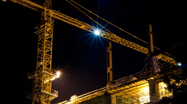 Building cranes at night — Stock Photo, Image