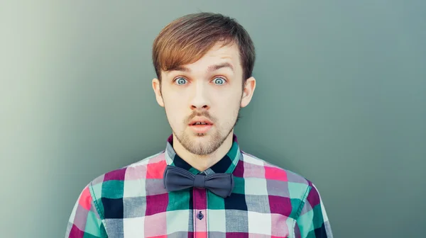 Young surprised man in shirt with bowtie — Stock Photo, Image