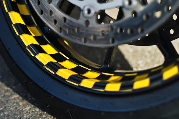 Wheel of motorbike on asphalt