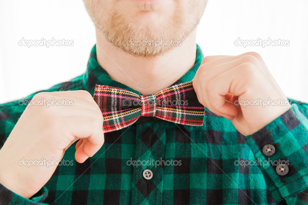 Fashion man correcting his tie