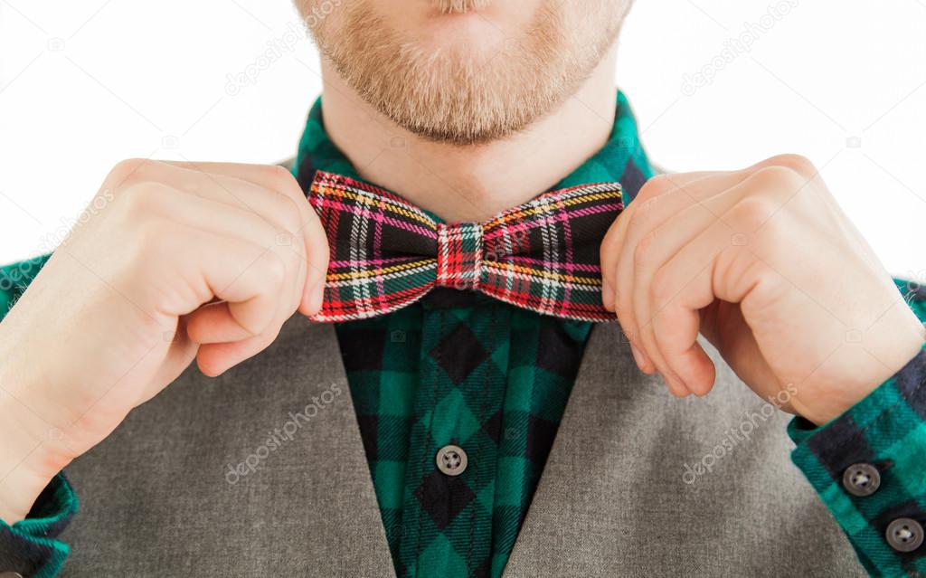 Retro fashion man correcting his bowtie