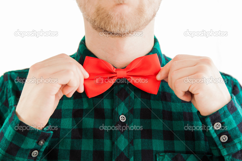 Fashion man correcting his tie