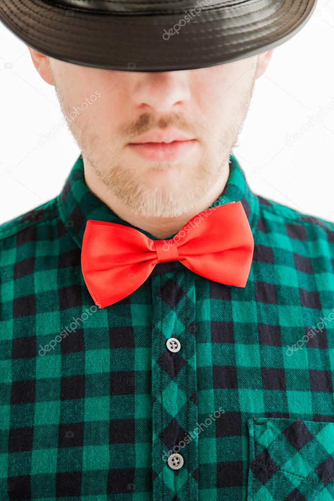 Young man in red bowtie and hat