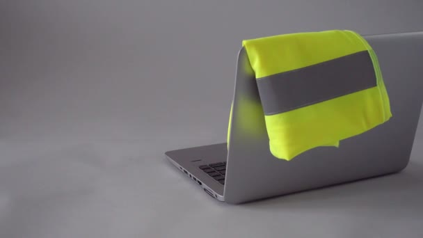 Construction engineer pitting helmet near laptop with vest — Video