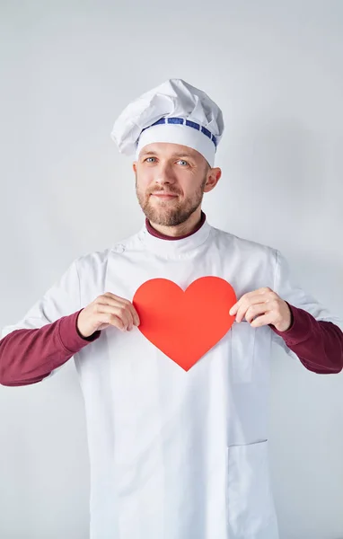 International Chefs Day concept: cute male chef with red heart