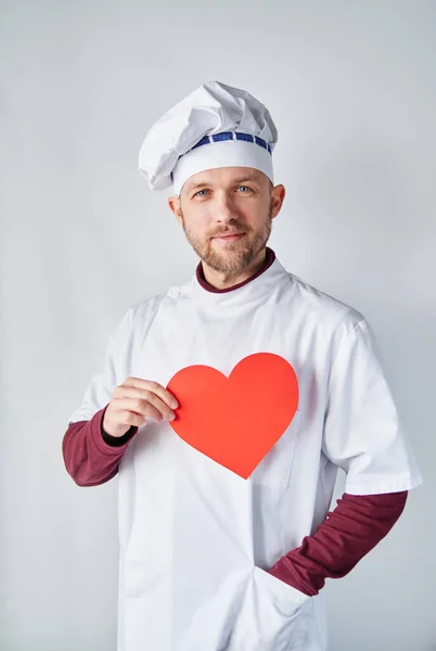 International Chefs Day: male chef or baker with red heart