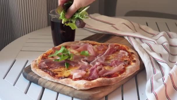 Mano espolvorea sabrosa pizza italiana casera con albahaca — Vídeos de Stock