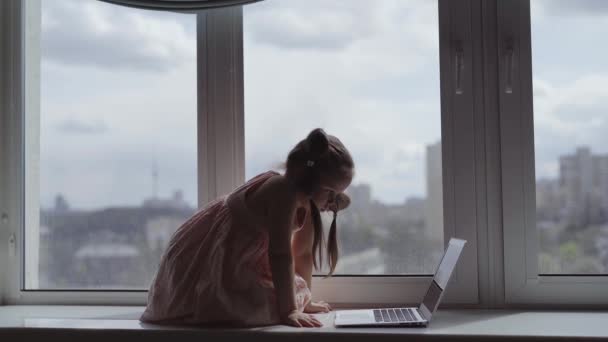 Cute Caucasian Small Child Using Laptop Computer Sitting Windowsill Home — Stockvideo