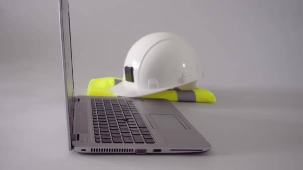 Engineer Putting Rolled Blueprints Table Laptop Computer White Hard Hat — Wideo stockowe