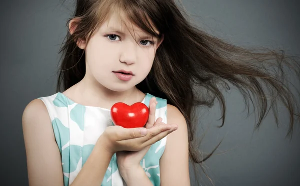 Little girl with a heart — Stock Photo, Image