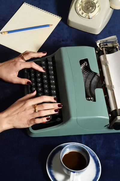 Woman working with vintage typewriter