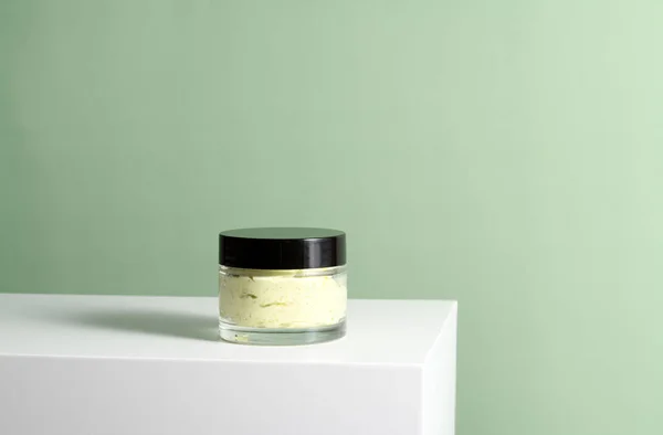 Glas Mit Grüner Kosmetikmaske Auf Weißem Ständer — Stockfoto