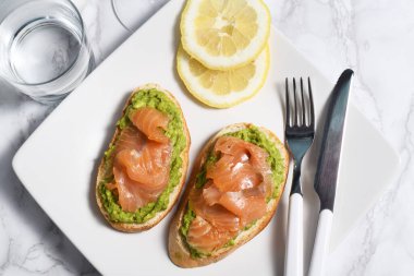 Two sandwiches with avocado and salmon, top view