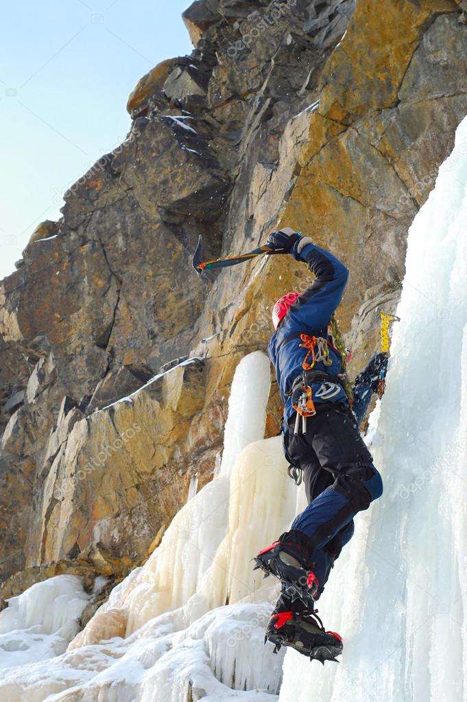Professional climber on icy waterfall