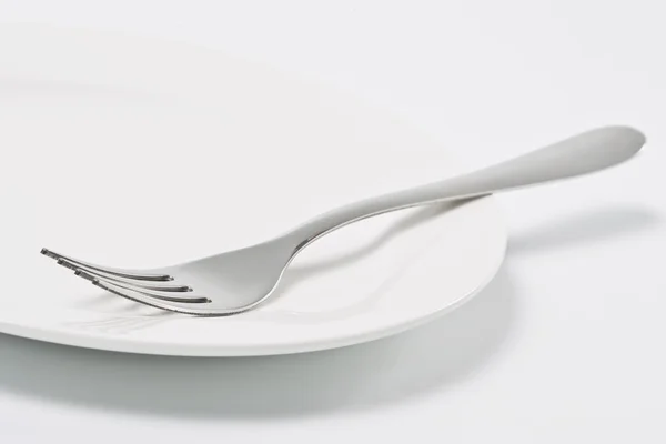 Empty plate and fork — Stock Photo, Image
