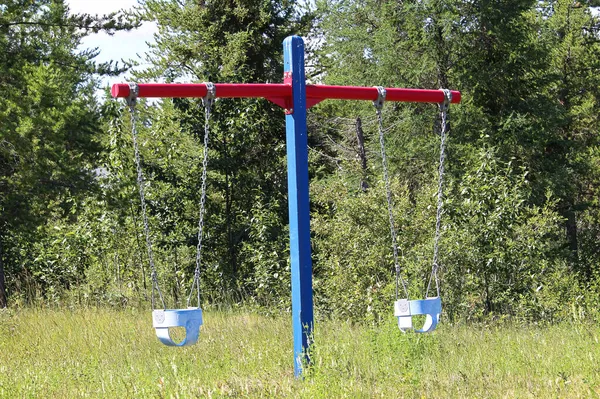 A view of baby swings in a playground — Stock Photo, Image