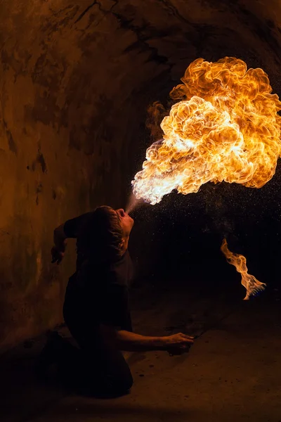 Young man blowing fire from his mouth — Stock Photo, Image