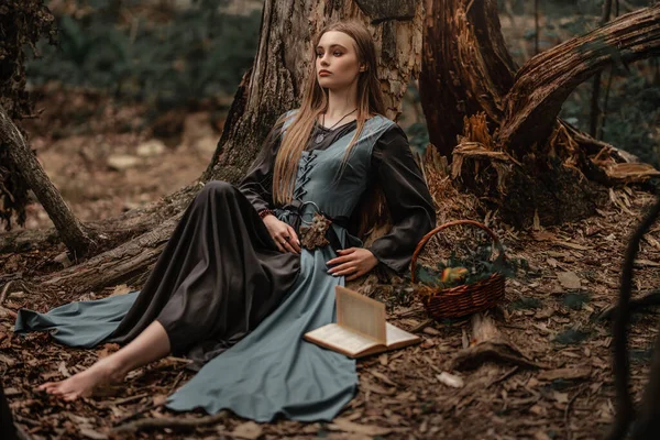 A mysterious witch walks in a dark forest — Stock Photo, Image