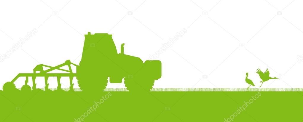 Agriculture tractors plowing the land in cultivated country fiel