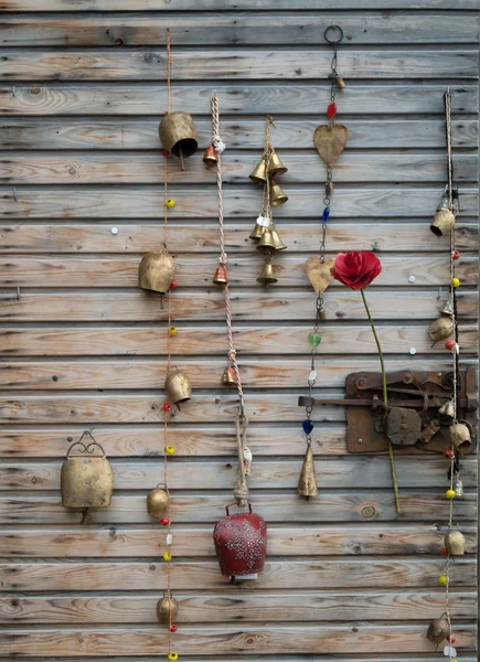 Handmade bells on wooden wall — Stock Photo, Image