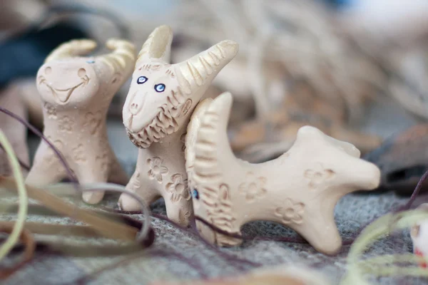 Interesting clay whistles in shape of goat — Stock Photo, Image