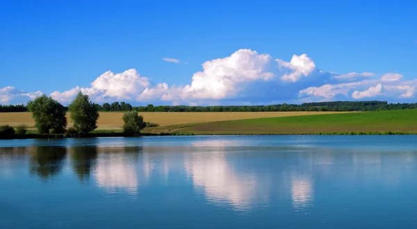 Paysage lac ciel bleu et reflets de nuages dans l'eau — Photo