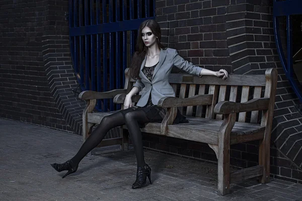 Young fashion model outdoor shoot posing wearing short black dress — Stock Photo, Image