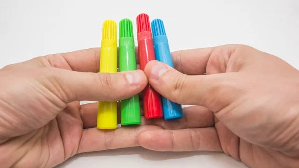 Hands holding pens — Stock Photo, Image